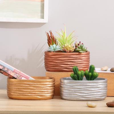 China Cement Creative Minimalist Luxury Oval Ceramic Gold Succulent Planter Pot Ribbon Flower Pot Planter Home Decoration for sale