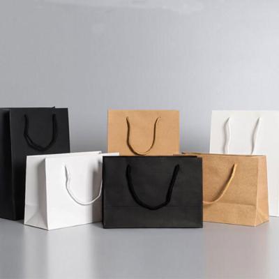 China Recycled Materials 2022 High End Paper Clothing Bags With Handles Mens Clothing Paper Bags Custom Paper Bags for sale