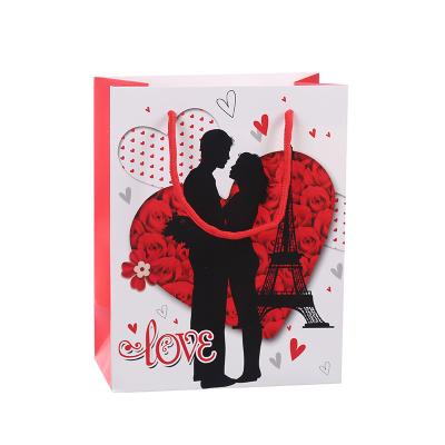 China Logo Printing Luxury Valentines Day Recyclable Couple Pattern Hot Custom Printed Gift Bag Craft Paper Paper for sale