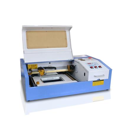 China Mini Laser Engraving Low Cost CO2 Laser Engraving Machine FL-K40 For Mobile Phone Cases for sale