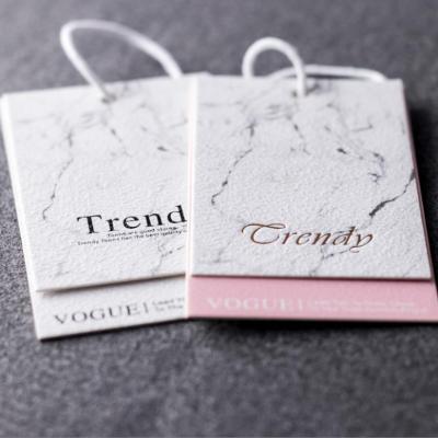 China Recyled DF Custom Shape Craft Debossed Cotton Bag Hanger High End Branded Printing Labels With Twine Apparel Kraft Paper Hanger Label for sale