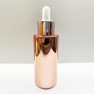 China OEM ODM Rose Gold Electroplating Glass Dropper Bottles Round Shape for sale