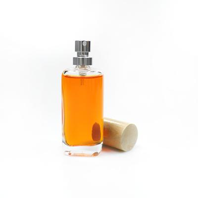 China 50ml 100ml Cosmetic Thick Bottom Round Glass Perfume Bottle Sprayer Bottle With Bamboo Lid for sale