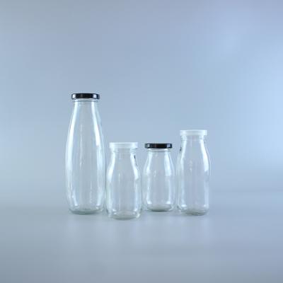 China Beverage 250ml 300ml 500ml 750ml 1L Clear Juice Bottle Glass Milk Bottle With Metal Lid Beverage Bottle for sale