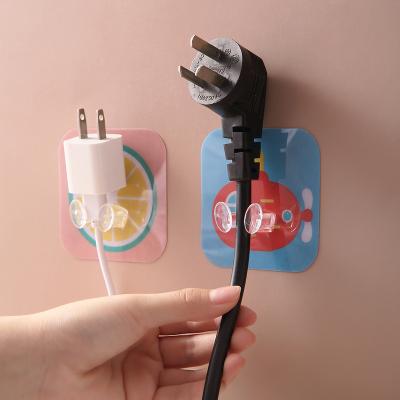 China Household Plastic Bathroom Wall Hook Power Outlet Socket Holder Seamless Pasting Adhesive Hook for sale