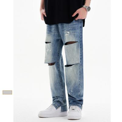 China Breathable Streetstyle Harajuku Streetwear Knee Hole Stacked Jeans Designer Lattice Loose Ripped Splatter Popular SAND WASH Mens Jeans for sale