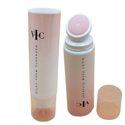 China Facial Cosmetics D40mm Detergent Plastic Packing Silicone Massage Cosmetic Tube With Brush Applicator for sale