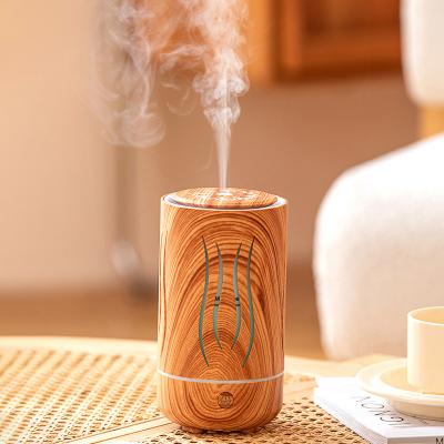 中国 New style mini aroma oil diffuser electric humidifier wood diffuser for essential oils with 7 colors 販売のため