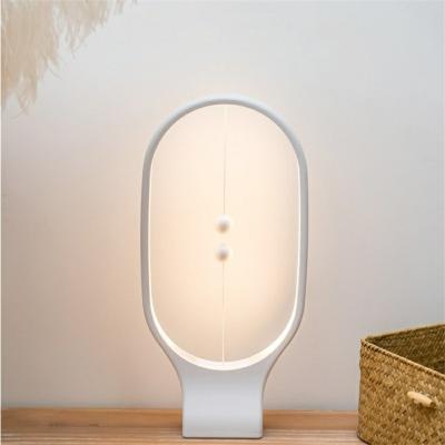 China A Creative Dimmable USB Rechargeable Ellipse Lamp Drop Shipping Balance LED Mid-Heaven Balance LED Modern Magnetic Eye-Care Night Light for sale