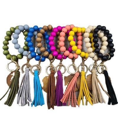 China 2021 Newest Fashionable Keychain Monogram Key Ring Wristlet Bangle Wooden Wood Bead Key Chain Bracelet Key Chain With Tassel for sale