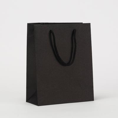 China 2022 Recycled Materials Customize Black Cardboard Paper Bags With Cotton Handles For Wedding Gift for sale