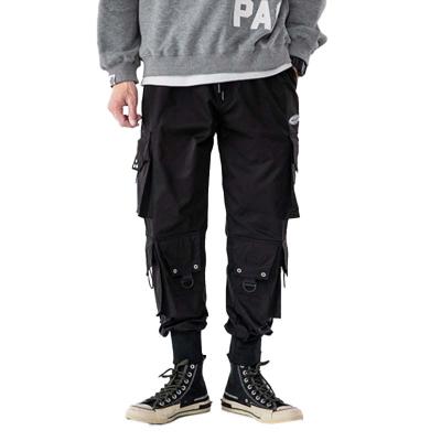 China Anti-wrinkle high street fashion brand functional wind cargo pants for men loose skydiver pants springs and fall for sale