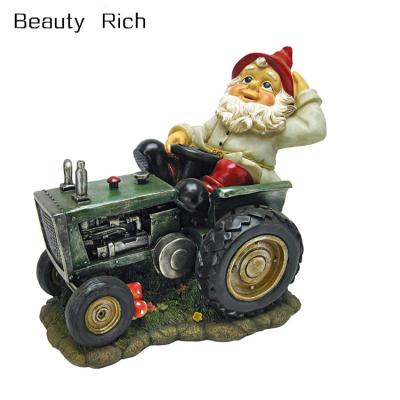 China Africa Polyresin / Resin Garden Gnome Statue Plowing Pete Garden Gnome Tractor Lawn Gnome for sale