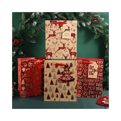 China Merry Christmas New Year Recyclable Luxury Kraft Paper Storage Bag Christmas Paper Gift Bags With Handles for sale