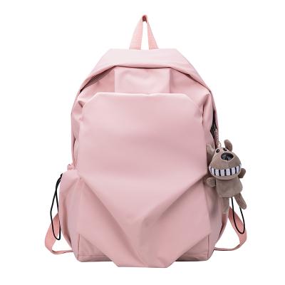 China Customizable Tear Resistance Fashionable Teens Solid Color Campus School Bag Nylon Multifunctional University With Doll Backpack for sale