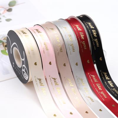 China Hot Stamping 25mm Holographic JUST LOVE YOU Satin Ribbon Flower Wrapping Ribbon Gift Box Bow Decoration Ribbon for sale