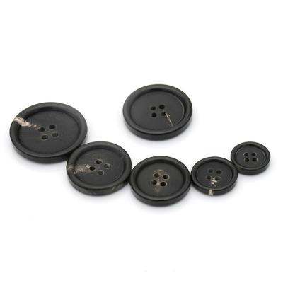 China Real Dry Cleaning Flatback 4 Black Hole Horn Buttons for sale