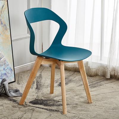 China Modern Cheap Commercial Furniture Indoor Stackable Plastic Dining Chairs With Wooden Legs for sale