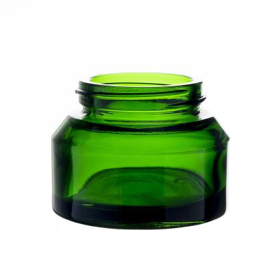 China Berlin Cosmetic Clear Mini Round Green Inclined Shoulder Small Cream Glass Jar Cosmetic Packaging Cream Lotion Jar for sale