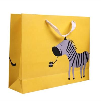 China Recycled Materials Yellow Cartoon Boutique Carrier Bags Packaging Bag Foldable Reusable Recyclable Paper Bag With Logo for sale