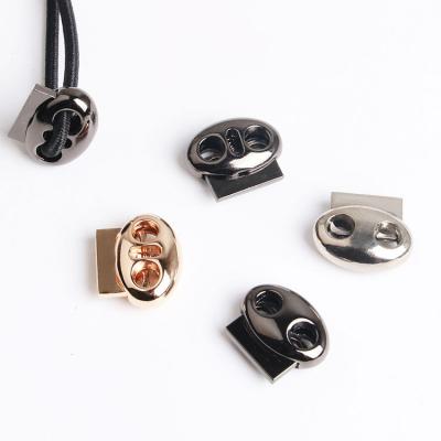 China Metal Metal Toggles Alloy Toggle Stoppers Metal Double Hole Spring Elastic Adjustment Buckle for Belt Windbreaker Backpack Cord Lock for sale