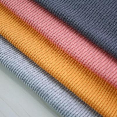 China Solid Color Tear-Resistant Waffle Knitted Jacquard Dyed 65 Polyester 35 Rayon Fabric For Garments for sale