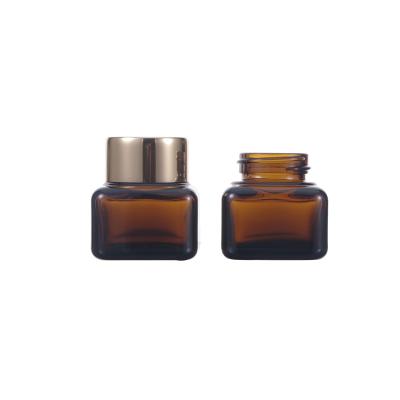 China Empty Dark Brown 15g Cosmetic Luxury Amber Color Cream Small Glass Square Jars Glass Cosmetic Jar With Gold Cap for sale