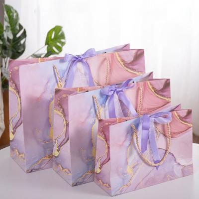 China Recyclable Private Label Pink And , Blue Gradient Wedding Gift Paper Bag With Ribbon Closure for sale