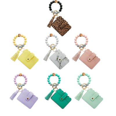 China Key Chain Card Holder Bead Bags 2021 Suede Bracelet Beads Tassel Elastic Wooden Circle Circle Summer Silicone Key Chain for sale