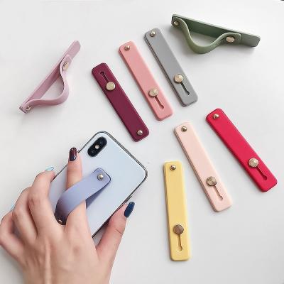 China Universal Silicone Silicon Phone Hand Band Holder Finger Ring Holder For IPhone Wristband Strap Grip Holder Push-Pull Candy Color Bracket for sale