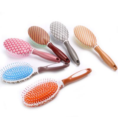 China Compact Oval Printing Stripe Comb Detangling Hair Brush for sale