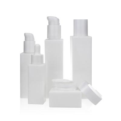 China 30ml 50ml 100ml 120ml Eco-friendly Recyclable Square Lotion Bottles Glass White Ceramic Opal Glass Cosmetic Bottle Set With Pump for sale