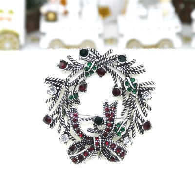 China Fashionable High Quality Antique Silver Plating Inlaid Bow Jewelry Women Alloy Christmas Diamond Inlay Flower Brooches for sale