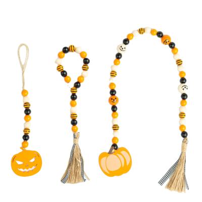 China Rustic Eco-friendly Halloween Wood Ornaments Wooden Bead Garland with Tassel or Hang Tag for Home Decor for sale