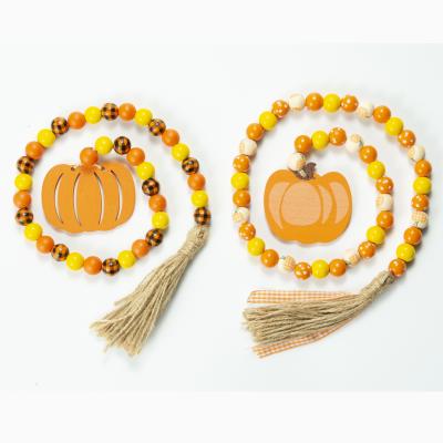 China DIY Eco-Friendly Customized Thanksgiving Ornaments Wooden Bead Wreath With Pumpkin Tassels And Hangtag for sale