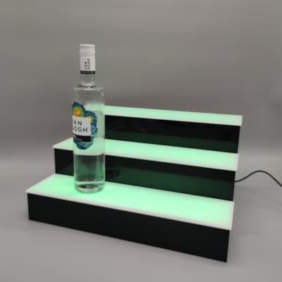 China Eco-friendly acrylic tiered led wine display bar wine bottle display stand for sale