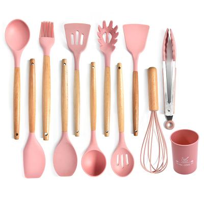 China Sustainable 11 Pieces Silicone Nonstick Kitchen Utensil Set With Wooden Handles And Rack for sale