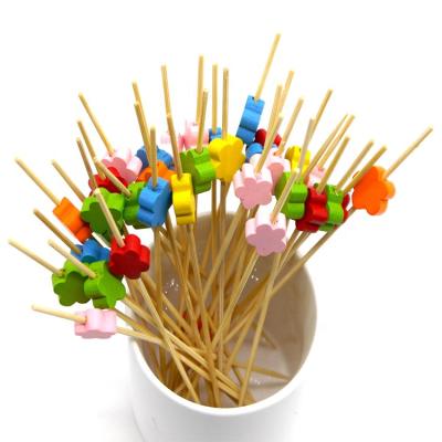 China Disposable Bamboo Cocktail Fruit Sandwich Spits Picks With Colorful Flower Wooden Beads For Party Restaurants 4.7