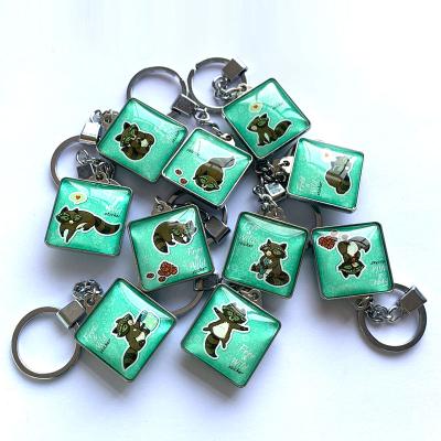 China Square wholesale custom high quality double-sided creative cute glass raccoon cartoon sticker mold sublimation key chain 3.2*10cm for sale