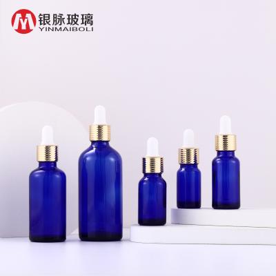 China Personal Care Empty Cosmetic Glass Bottle 50ml Essential Oil Dropper Bottle Blue Glass Bottles With Dropper Honeycomb Ring Cap for sale