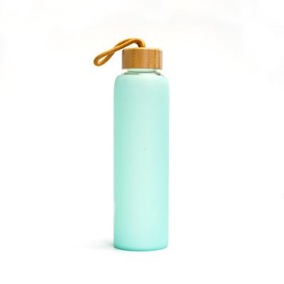 China Sustainable Sale Silicone Sleeve Borosilicate Glass Hot Water Bottle With Bamboo Lid for sale