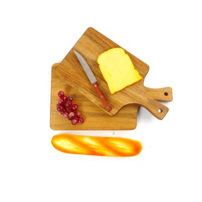 China New Design Custom Acacia Wood Kitchen Stocked Fruit Pizza Cheese Serving Cutting Board With Hole for sale