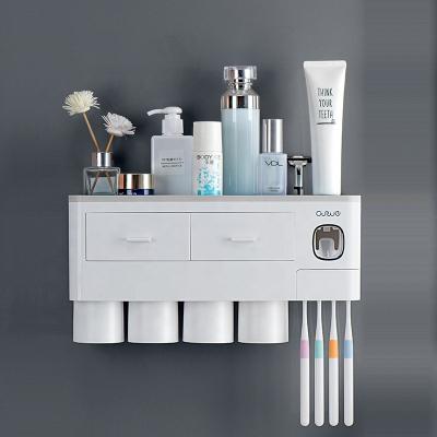 China Nordic Luxury Automatic Toothpaste Dispenser Toothpaste Squeezer Dispenser Plastic Wall Mount For Bathroom Toothbrush Holder for sale