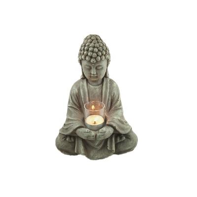 China Handmade Candle Holder Buddha Meditation Oxide Magnesium Buddha Statue Glass Candle Holder for sale