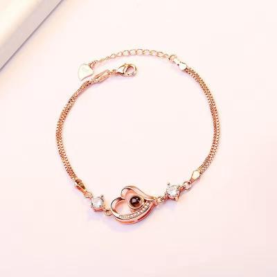 China Rose Gold Plated 2021 TRENDY I love you Crystal Heart Pendant Bracelet Romantic Jewelry 100 Language Projection Chain for Women Gift for sale