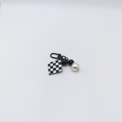 China Simple and beautiful bell black and white acrylic pendant key chain for sale