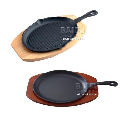 China Sustainable Cast Iron Sizzling Pan Fajita Pans Non-Stick Sizzling Dish With Wooden Base for sale