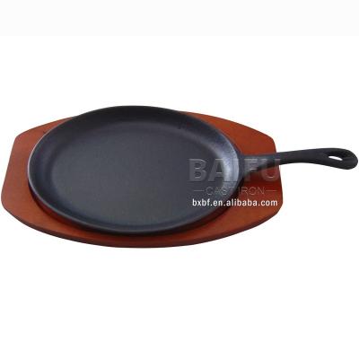 China Sustainable Cast Iron Sizzling Pan Fajita Pans Non-Stick Sizzling Dish With Wooden Base for sale