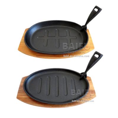 China Non-Stick Cast Iron Steak Serving Oval Steak Pan Viable Fajita Sizzler Dishes With Wooden Base Tray Sizzler Plate Steak Pan for sale