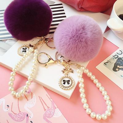 China New Imitation Lady Bag Accessories Plush Faux Stone Pearl Fox Head Key Chain Rex Rabbit Fur Pompom Hair Ball Key Chain for sale